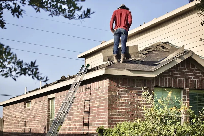 Professional roofer working on a residential roof in Candlewood Orchards